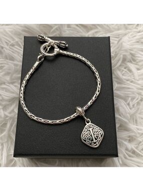 Silver woven bracelet with “i” charm